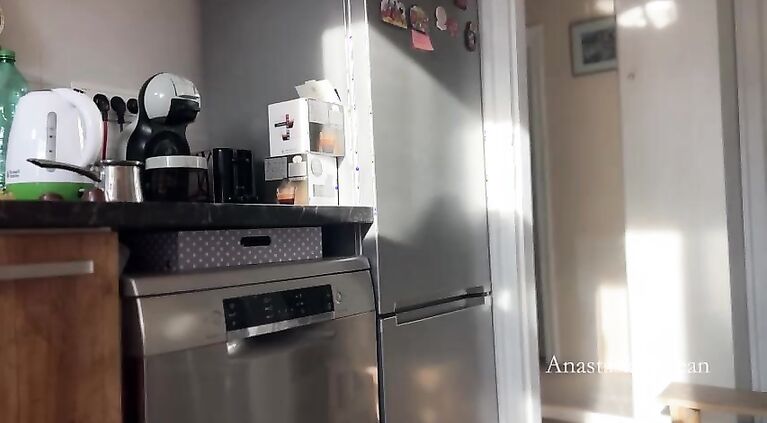 Sunny morning and she is making coffee in stokings and hills. Voyeurism.