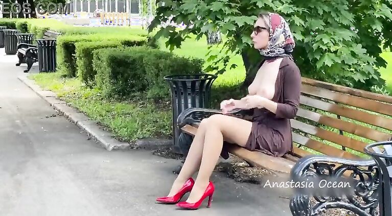 A girl shows her breasts while walking around the square. public